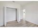 Bright bedroom features neutral walls, wood-look flooring, and a closet with bi-fold doors at 14961 Sw 38Th Cir, Ocala, FL 34473