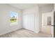 Bright bedroom with neutral walls, wood-look flooring, and a closet with sliding doors at 14961 Sw 38Th Cir, Ocala, FL 34473