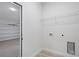 Compact laundry area includes washer/dryer hookups and a wire shelf for storage at 14961 Sw 38Th Cir, Ocala, FL 34473