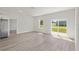 Bright open-concept living area with sliding glass doors and light wood-look flooring at 14961 Sw 38Th Cir, Ocala, FL 34473