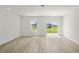 Spacious living room featuring neutral walls and trim and sliding glass doors to the backyard at 14961 Sw 38Th Cir, Ocala, FL 34473