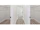 Walk-in closets feature wire shelving, laminate flooring, and bright white walls at 14961 Sw 38Th Cir, Ocala, FL 34473