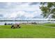Tranquil lakeside community area with a bocce court, picnic table, and Adirondack chairs for relaxing at 151 N Orlando Ave # 115, Winter Park, FL 32789