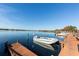 Scenic dock with boats on a calm lake, perfect for enjoying water activities and serene views at 151 N Orlando Ave # 115, Winter Park, FL 32789