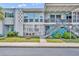 Attractive two-story condo building with unique architectural details and well-maintained lawn at 151 N Orlando Ave # 115, Winter Park, FL 32789