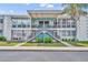 Charming condo with striking blue accents and lush landscaping, offering a welcoming facade and curb appeal at 151 N Orlando Ave # 115, Winter Park, FL 32789