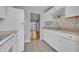 Bright and airy kitchen with stainless steel appliances, ample counter space, and open access to the living room at 151 N Orlando Ave # 115, Winter Park, FL 32789