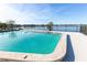 Inviting pool overlooking a serene lake with a clear blue sky as the perfect backdrop at 151 N Orlando Ave # 115, Winter Park, FL 32789