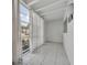 Sunroom featuring large windows, white walls, tiled floor, and sheer curtains at 151 N Orlando Ave # 115, Winter Park, FL 32789