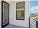 This is a covered balcony with black trim and black metal railing at 15483 Hamlin Park Drive, Winter Garden, FL 34787