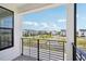 A cozy balcony view overlooking a neighborhood on a bright and sunny day at 15483 Hamlin Park Drive, Winter Garden, FL 34787