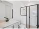 Modern bathroom featuring a sleek glass-enclosed shower, stylish vanity, and clean white finishes at 15483 Hamlin Park Drive, Winter Garden, FL 34787