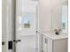 Bathroom vanity showing the entry door to a bedroom with lots of natural light at 15483 Hamlin Park Drive, Winter Garden, FL 34787