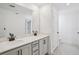 A bright bathroom featuring a double vanity, modern fixtures, and tile floors at 15483 Hamlin Park Drive, Winter Garden, FL 34787