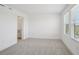 Light and airy bedroom showcasing a large window and an open en-suite bathroom at 15483 Hamlin Park Drive, Winter Garden, FL 34787