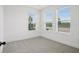 Bright, airy bedroom features neutral carpet and three large windows offering scenic views at 15483 Hamlin Park Drive, Winter Garden, FL 34787
