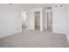 A bright, unfurnished bedroom with neutral carpet, white walls, and doors to bathroom and closet at 15483 Hamlin Park Drive, Winter Garden, FL 34787