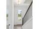 Bright entryway boasts modern staircase with stylish railings, wood floors, and natural light at 15483 Hamlin Park Drive, Winter Garden, FL 34787