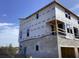 Construction of a townhome with visible framework, walls and window installation in progress at 15483 Hamlin Park Drive, Winter Garden, FL 34787