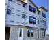 A close-up of a townhome under construction, highlighting the exterior walls and window placement at 15483 Hamlin Park Drive, Winter Garden, FL 34787