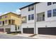 Modern two-story townhomes featuring private balconies, dark frame windows, and convenient two-car garages at 15483 Hamlin Park Drive, Winter Garden, FL 34787
