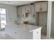 Bright kitchen featuring a center island and gray cabinets providing ample storage at 15483 Hamlin Park Drive, Winter Garden, FL 34787