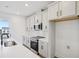 Modern kitchen boasts stainless appliances, an island with a sink, and ample counter and cabinet space for the home chef at 15483 Hamlin Park Drive, Winter Garden, FL 34787