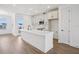 Modern kitchen with stainless appliances, an island with a sink and breakfast bar, and plenty of cabinet space at 15483 Hamlin Park Drive, Winter Garden, FL 34787