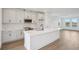 Modern kitchen features a central island with a sink and breakfast bar, stainless appliances, and ample storage at 15483 Hamlin Park Drive, Winter Garden, FL 34787