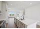 Modern kitchen with stainless appliances, island with breakfast bar, and open floor plan is perfect for cooking and entertaining at 15483 Hamlin Park Drive, Winter Garden, FL 34787