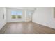 Bright living room boasts natural light, wood floors, and neutral paint, creating a cozy and inviting atmosphere at 15483 Hamlin Park Drive, Winter Garden, FL 34787