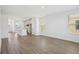 Open floor plan features wood floors connecting the living area to the modern kitchen with a spacious center island at 15483 Hamlin Park Drive, Winter Garden, FL 34787