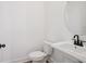 A contemporary powder room features a white vanity, toilet, and modern fixtures at 15483 Hamlin Park Drive, Winter Garden, FL 34787