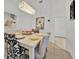 Bright dining area featuring an elegant table setting and stylish decor, perfect for gatherings at 162 Plumoso Loop, Davenport, FL 33897