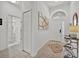 Bright foyer boasts tile flooring, high ceilings, and stylish decor; access to bathroom at 162 Plumoso Loop, Davenport, FL 33897