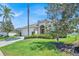 Inviting single-Gathering home with verdant lawn, decorative shrubbery, and convenient two-car garage at 162 Plumoso Loop, Davenport, FL 33897