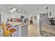 Open kitchen area with a breakfast bar featuring granite countertops, stainless steel appliances and white cabinets at 162 Plumoso Loop, Davenport, FL 33897