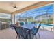 Screened lanai with dining table overlooking the sparkling pool at 162 Plumoso Loop, Davenport, FL 33897