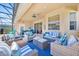 Covered lanai with comfortable seating and plenty of space to relax at 162 Plumoso Loop, Davenport, FL 33897