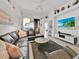 Spacious living room with a large sectional sofa, a flat-screen TV, and an inviting atmosphere at 162 Plumoso Loop, Davenport, FL 33897