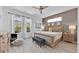 Serene main bedroom with a king-size bed, neutral tones, and a view of the pool from the large windows at 162 Plumoso Loop, Davenport, FL 33897