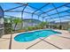 Private screened pool area with manicured landscaping for outdoor enjoyment at 162 Plumoso Loop, Davenport, FL 33897