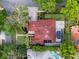 Aerial view of a tile roofed home with pool, lush landscaping and an elegant driveway at 1803 Glenbay Ct, Windermere, FL 34786