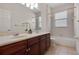 Bright bathroom with a double sink vanity, tile flooring and a shower-tub combination at 1803 Glenbay Ct, Windermere, FL 34786