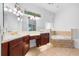 Double vanities and soaking tub featuring tile surround at 1803 Glenbay Ct, Windermere, FL 34786