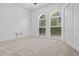 Bedroom with carpet, two large windows and a closet with panel doors at 1803 Glenbay Ct, Windermere, FL 34786