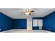 Finished bonus room with blue painted walls and carpeted flooring at 1803 Glenbay Ct, Windermere, FL 34786