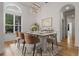 Dining room with hardwood floors, modern chandelier, and a large window for natural light at 1803 Glenbay Ct, Windermere, FL 34786