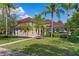Beautiful two-story home with tile roof, well-manicured lawn, and mature palm trees at 1803 Glenbay Ct, Windermere, FL 34786