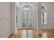 Bright foyer with decorative glass double doors, hardwood floors, and clerestory windows at 1803 Glenbay Ct, Windermere, FL 34786